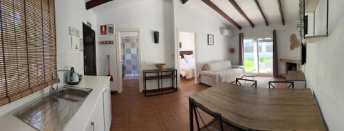 a kitchen and living room with a sink and a table at Banus Lodge in Marbella