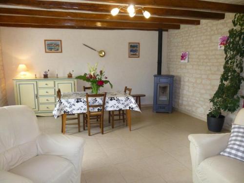 a living room with a table and chairs at Clé des champs in Antran