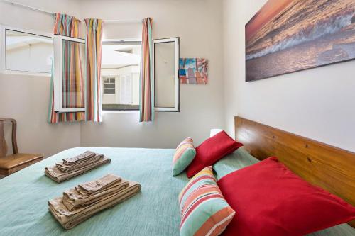 a bedroom with a bed with two towels on it at Formosa Beach in Porto Santo
