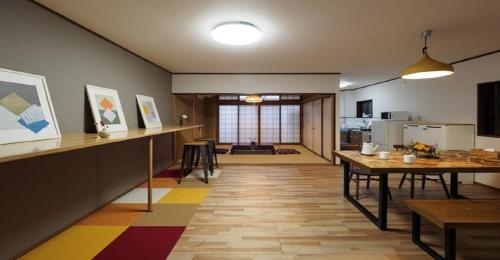 a living room with a table and a kitchen at Kyoto Hostel japanese room 2F / Vacation STAY 8178 in Kyoto