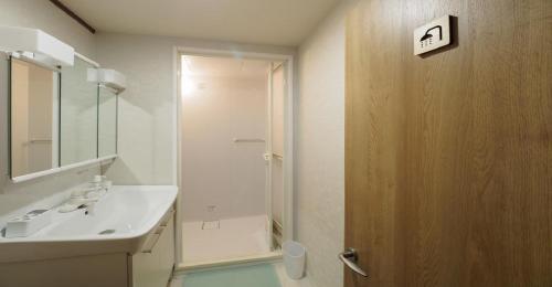 a bathroom with a white sink and a shower at Kyoto Hostel japanese room 3F / Vacation STAY 8183 in Kyoto