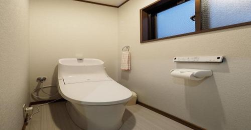 a bathroom with a white toilet and a window at Kyoto Hostel japanese room 3F / Vacation STAY 8183 in Kyoto