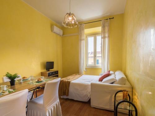 a bedroom with a bed and a table with chairs at The Best Rent - Colourful two-bedroom apartment near Termini Station in Rome