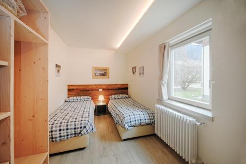 Tempat tidur dalam kamar di Appartamenti Residence Lares Ossana