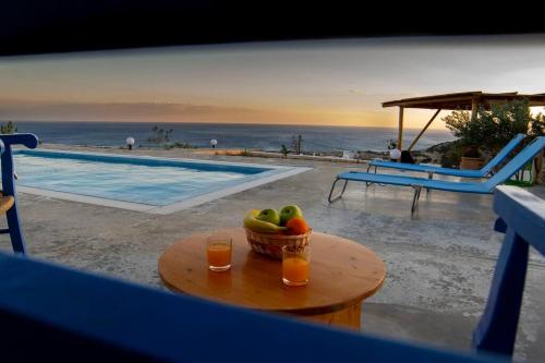 un bol de fruta en una mesa junto a una piscina en Sea view Villa, en Koutsounari