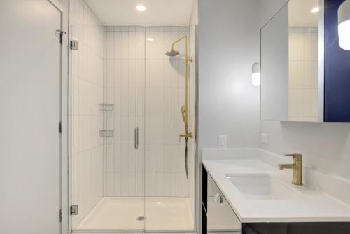 a shower with a glass door next to a sink at River N 1BR w Gym Pool WD nr Mag Mile CHI-440 in Chicago