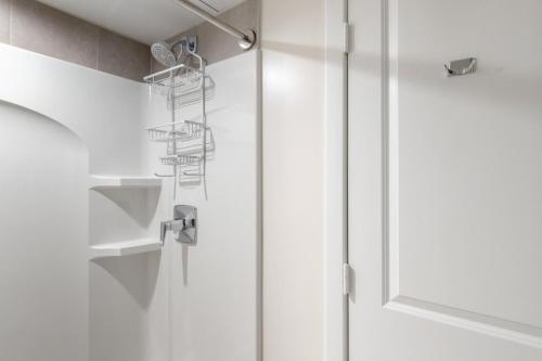 a shower with a glass door with a shower head at Ballston 1br w wd gym pool nr Metro WDC-615 in Arlington