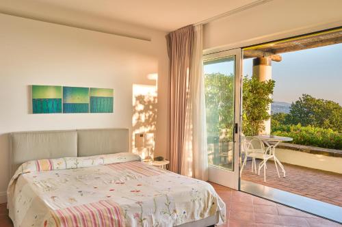 a bedroom with a bed and a balcony at Borgo La Pietraia in Paestum