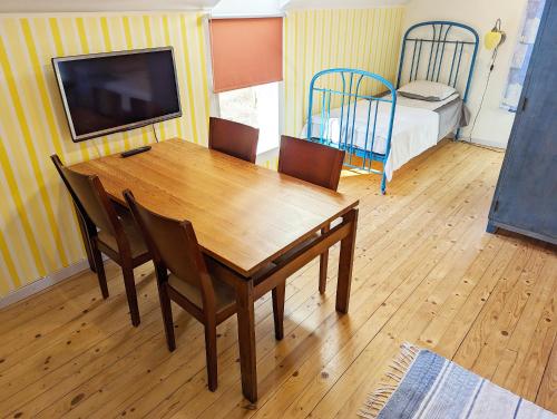 - une salle à manger avec une table, des chaises et un lit dans l'établissement Kaberneeme Puhkemaja - Kaberneeme Vacation House, à Kaberneeme