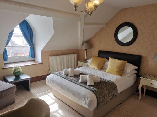 a bedroom with a large bed and a large window at Llety Teifi Guest House in Cardigan