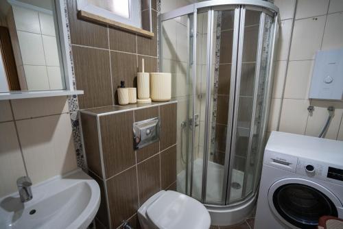 a bathroom with a toilet and a washing machine at River Park Residence Lara in Antalya