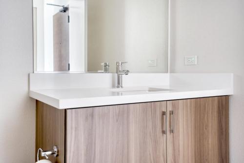 a bathroom with a white sink and a mirror at Menlo Park 1BR w Lounge WD nr Caltrain SFO-993 in Menlo Park