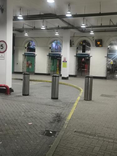 a parking garage with a row of metal trash cans at Sublime Jadwin, Liverpool Lime City in Liverpool