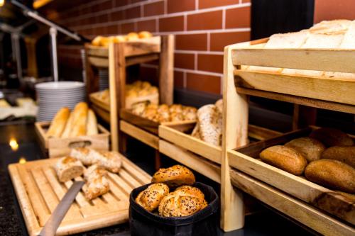 a bakery with lots of different types of bread at Vienna House Easy by Wyndham Bucharest Airport in Otopeni