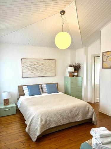 a bedroom with a large bed with blue pillows at Villa Roma Holidays in Jesolo