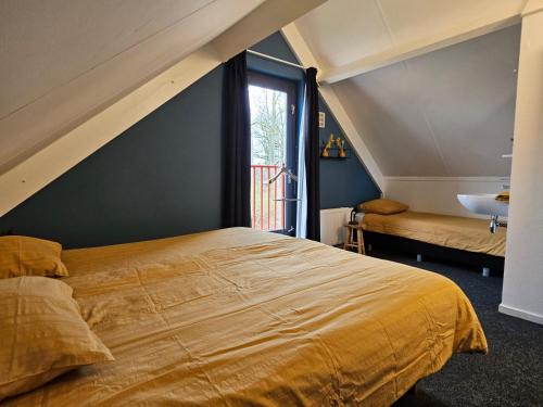 a bedroom with a large bed and a sink at 7 person House with swing, firepit, hammock, garden, swimming lake, child friendly, in- and outside playground, and great coffee in Ewijk