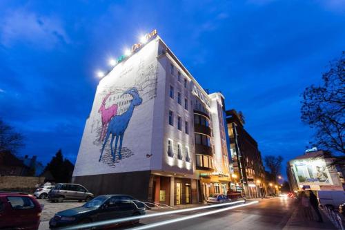 a building with a painting of a bird on the side of it at Hotel DeSilva Premium Poznań in Poznań
