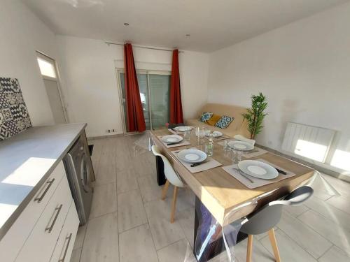 une cuisine avec une table et des chaises dans une pièce dans l'établissement Maison cosy 3 chambres à la campagne, à LʼAbergement-Sainte-Colombe