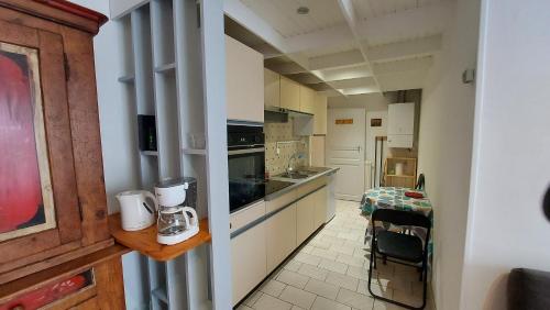 a kitchen with white cabinets and a counter top at 20 Rue Châtel in Verdun