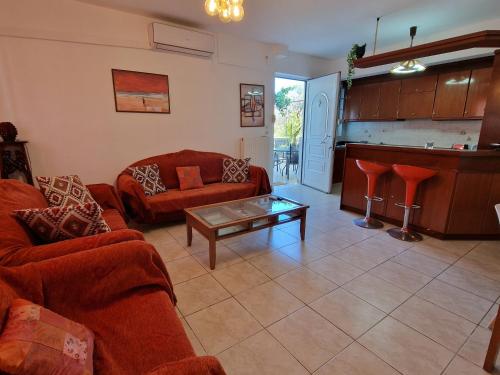 a living room with two couches and a table at Maria's Apartments in Pigi