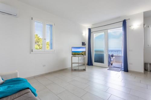 a living room with a view of the ocean at Appartamenti Rocca 'Ja in Castelsardo