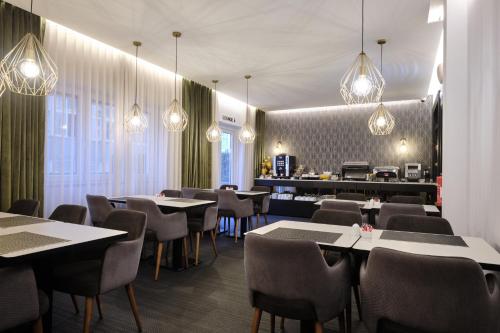 a restaurant with tables and chairs and lights at Duplo Charme Boutique Hotel in Lisbon