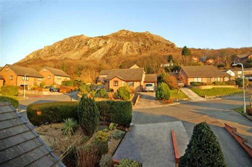 a view of a house with a mountain in the background at Sunset View in Llanfairfechan
