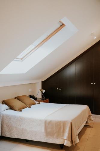 a bedroom with a large bed with a black wall at Apartamentos Poniente - Mares in Torre del Mar