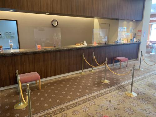 a waiting area with two chairs and a counter at Natural Farm City Noen Hotel in Chichibu
