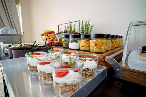 a buffet with several containers of food on a table at Kyparissia Beach Hotel in Kyparissia