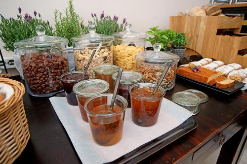 a table with many jars of different types of food at Kyparissia Beach Hotel in Kyparissia