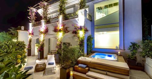 a house with a hot tub on the side of it at Hotel Villa Blu Capri in Anacapri