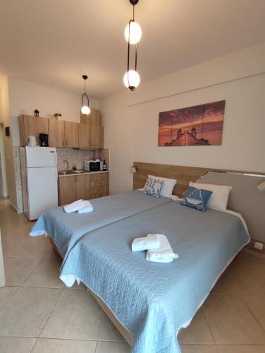 a bedroom with a large bed with towels on it at KSP Studios in Perea