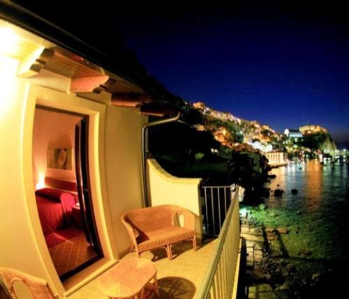 a balcony with a chair and a view of the water at B&B La Veduta in Scilla