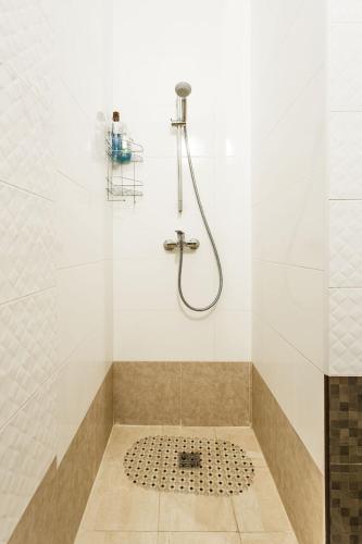 a bathroom with a shower with a tile floor at Gagarin Plaza apartment 70 square metres on 12th floor in Odesa