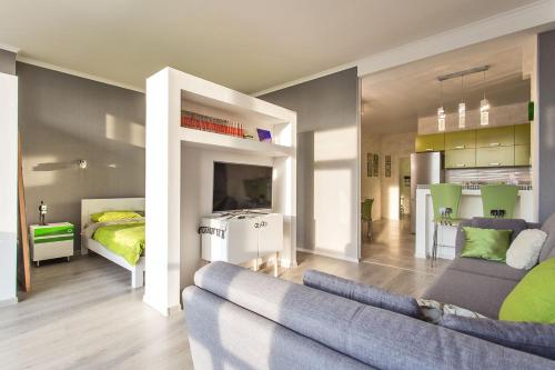 a living room with a couch and a bedroom at Gagarin Plaza apartment 70 square metres on 12th floor in Odesa