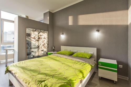 a bedroom with a large bed with green pillows at Gagarin Plaza apartment 70 square metres on 12th floor in Odesa