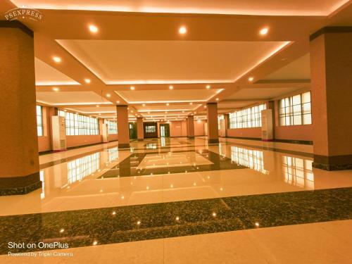 a large building with a large lobby with a pool at Hotel Jyoti International in Āsansol