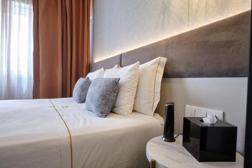 Un ou plusieurs lits dans un hébergement de l'établissement Duplo Charme Boutique Hotel