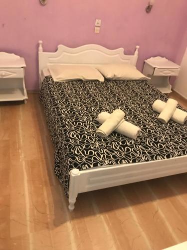 a white bed with four pillows on it at Pansion Angela in Skiathos Town