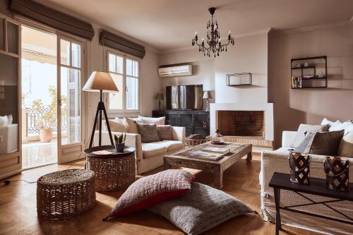 a living room with a couch and a fireplace at Plaka's Villa with Breathtaking Acropolis view in Athens