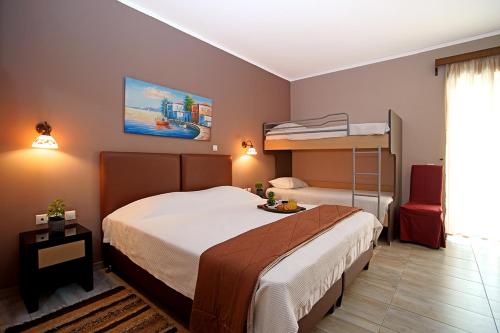 a bedroom with a bed and a bunk bed at Kyparissia Beach Hotel in Kyparissia