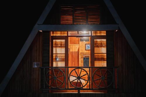 a window on a house with a balcony at Nsaho resort in Fort Portal