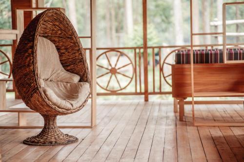 a chair sitting in a room next to a piano at Nsaho resort in Fort Portal