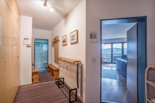 a hallway with a door leading to a living room at Appartment 160, 80qm in Obertal