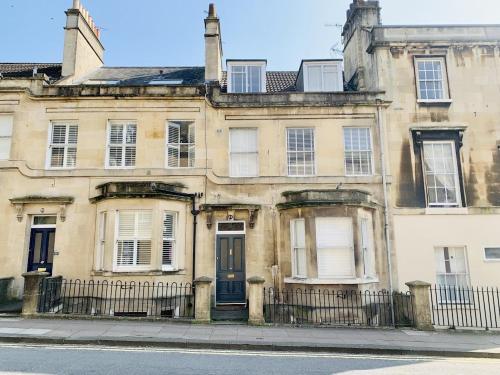 an old building with a blue door on a street at 5 Bedroom magnificent Georgian Townhouse- city centre in Bath