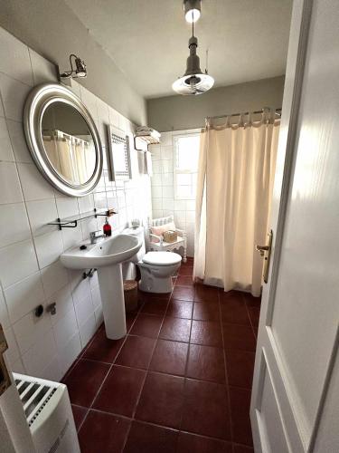 a bathroom with a sink and a toilet and a mirror at ATICO ELOY DELGADO in San Miguel de Abona