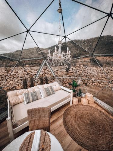 a living room with a bed and a chandelier at Suite con Burbuja in Canyelles