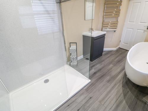a bathroom with a glass shower and a sink at Fellend House in Bishop Auckland