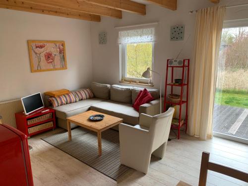 a living room with a couch and a table at Gästehaus A+C Bovet in Wesenberg